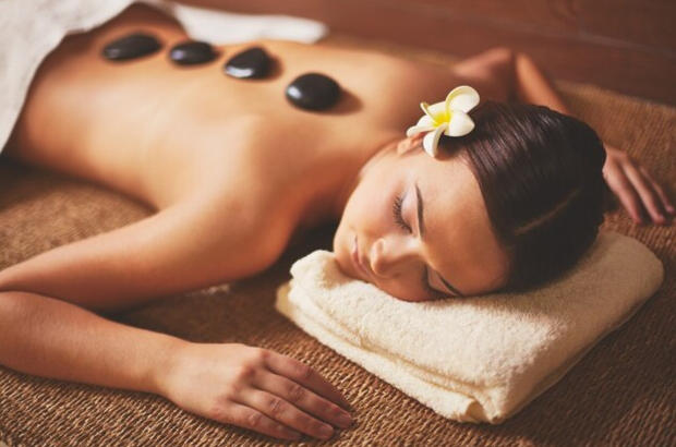 Hot stone massage involves the use of smooth, heated stones placed on specific points of the body to promote relaxation, relieve muscle tension, and improve circulation.